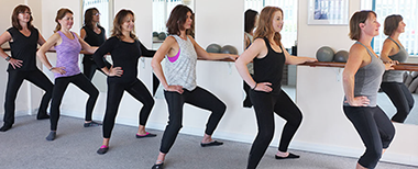 Thigh firming exercise at the barre Standing at the barre bending knees